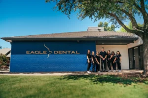 Eagle Dental team outside of the office with a blue sky